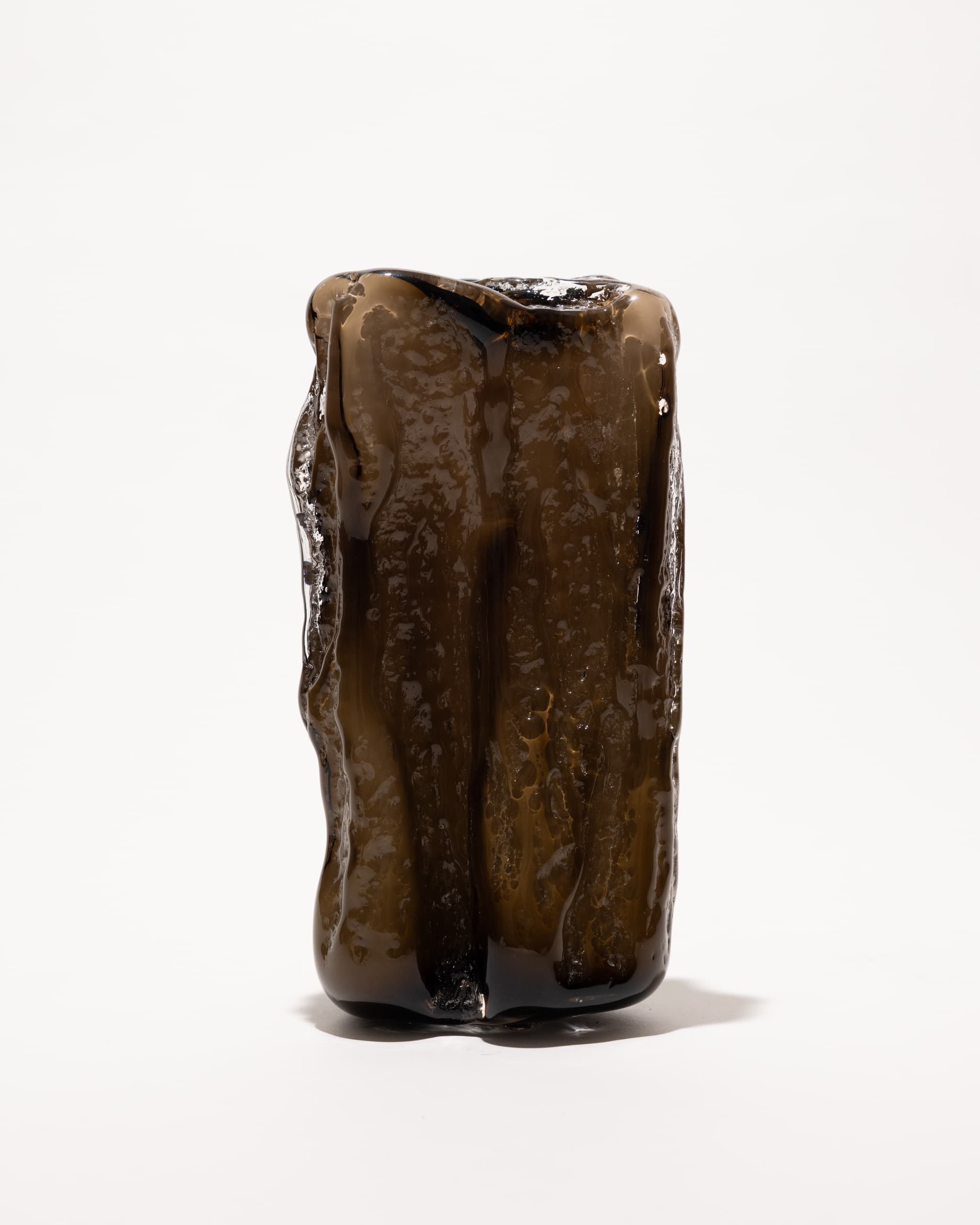 A dark smoked-glass cast, out of the mould, unlit