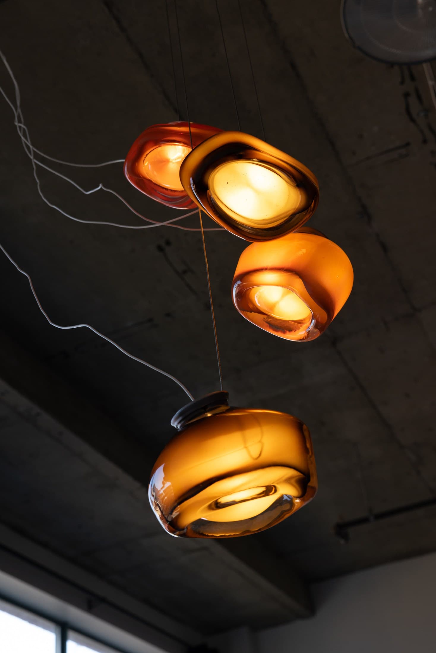 Barnacle pendants, lit, hung as a cluster