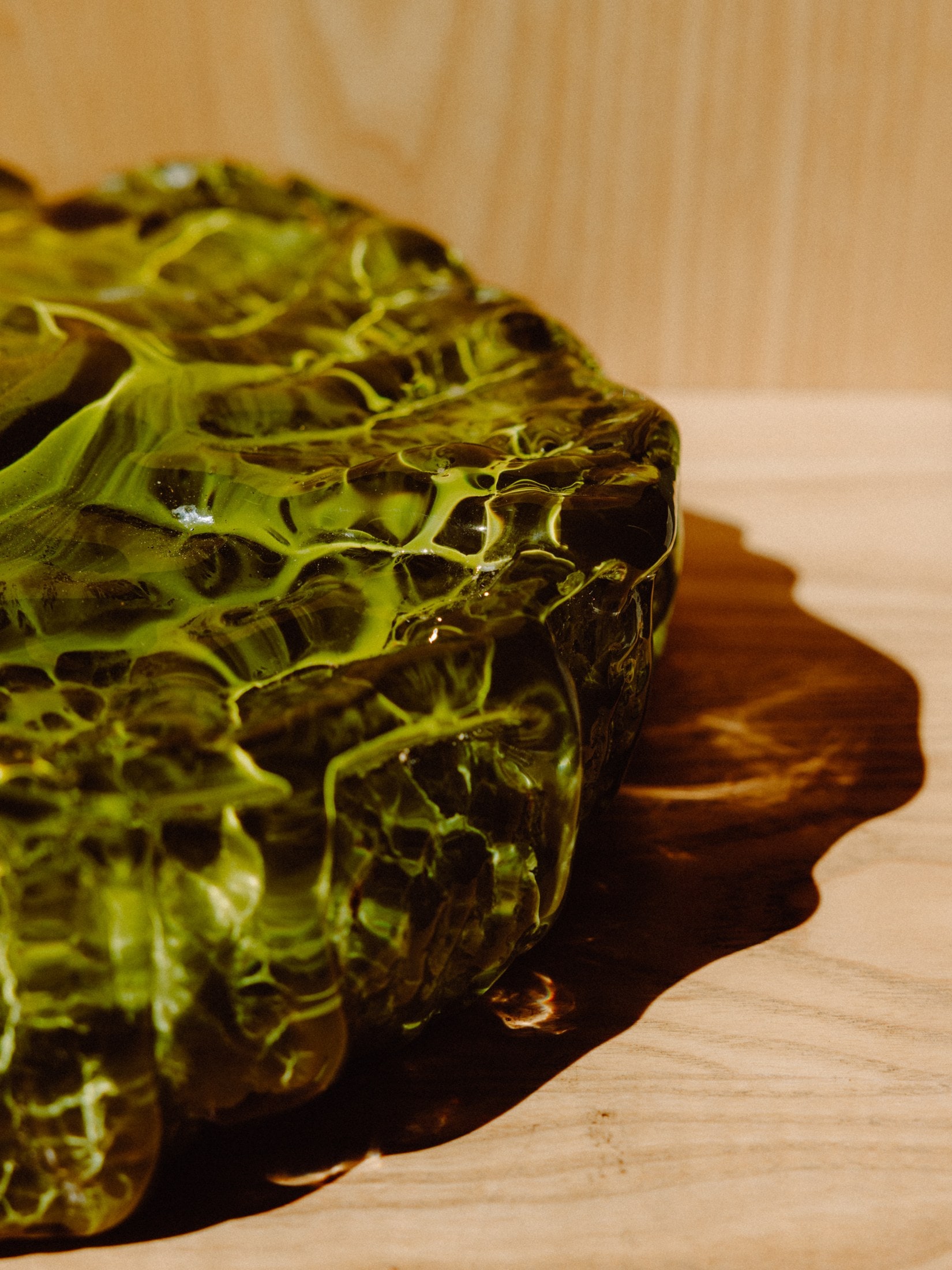 Green glass, lit from within, in the studio