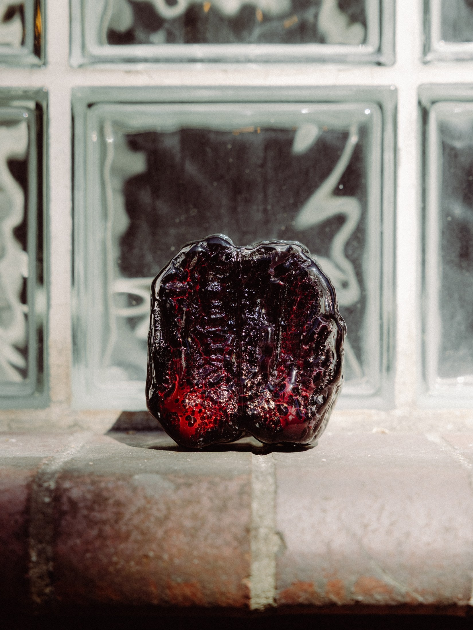 An oxblood cast, lit low