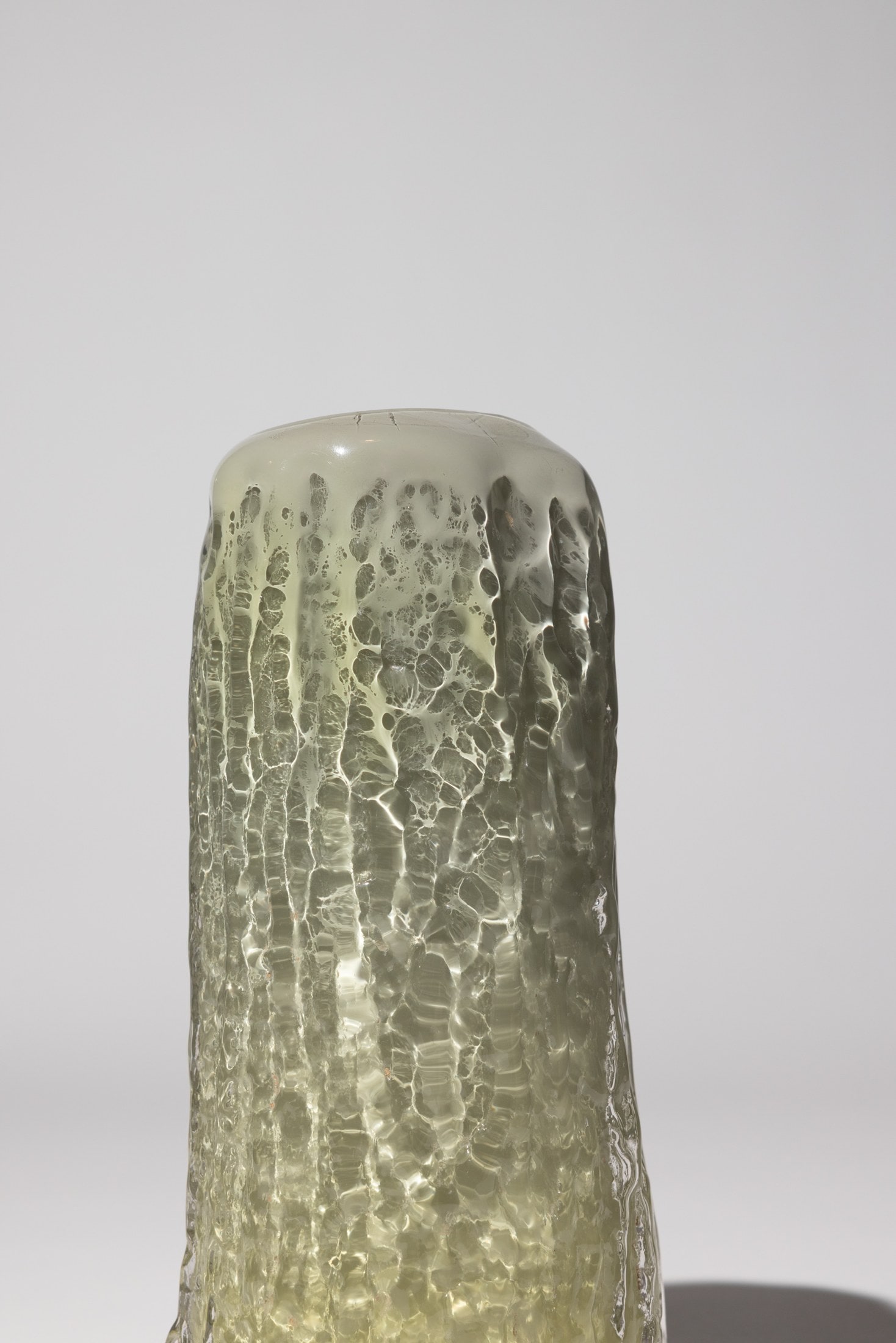 A grey bark vase on white