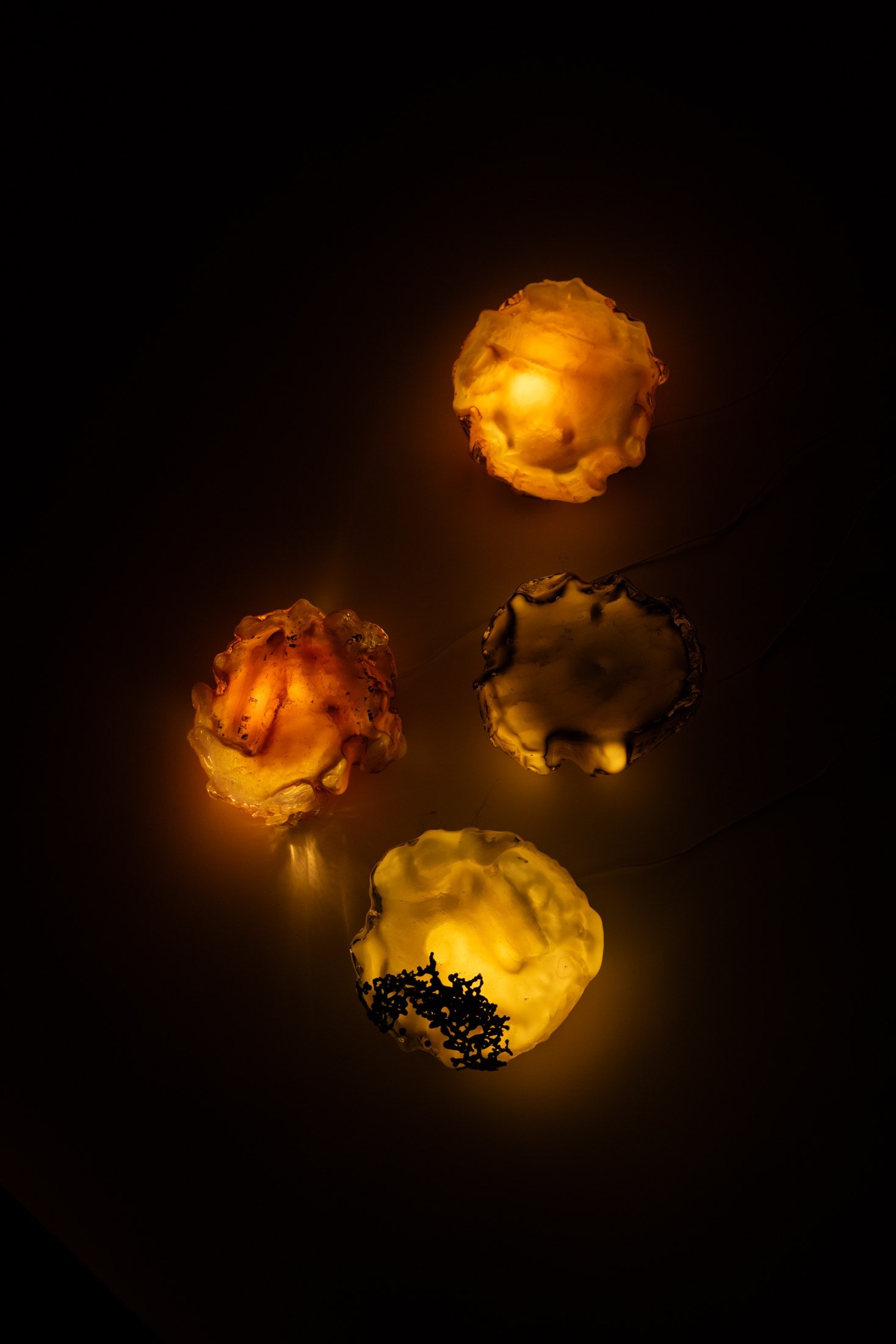 Four sconces lit on the dark floor