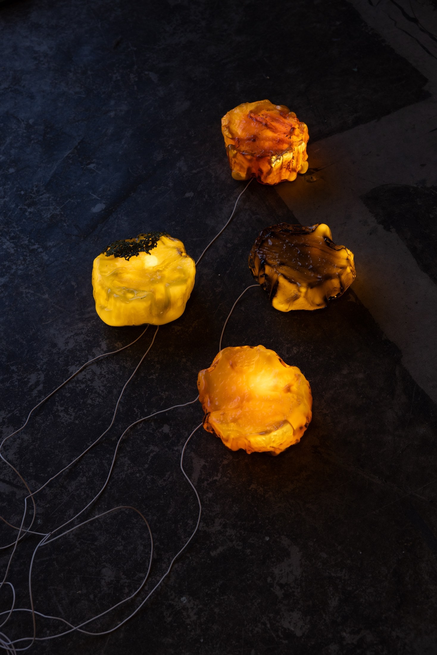 Three sconces lit on the dark floor