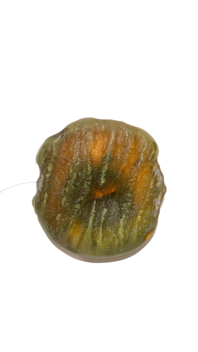 The Sconce's moss green pour over amber, on white